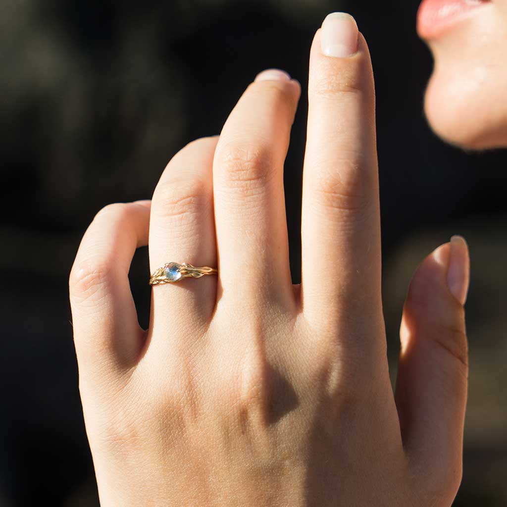 14K gold rainbow moonstone ring on hand
