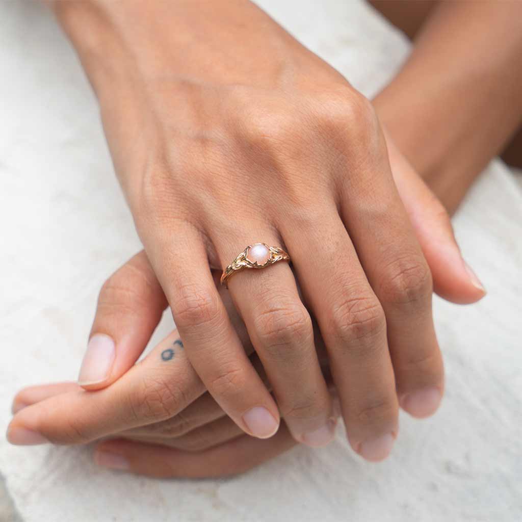 elegant-14K gold peach moonstone unique engagement ring on hand